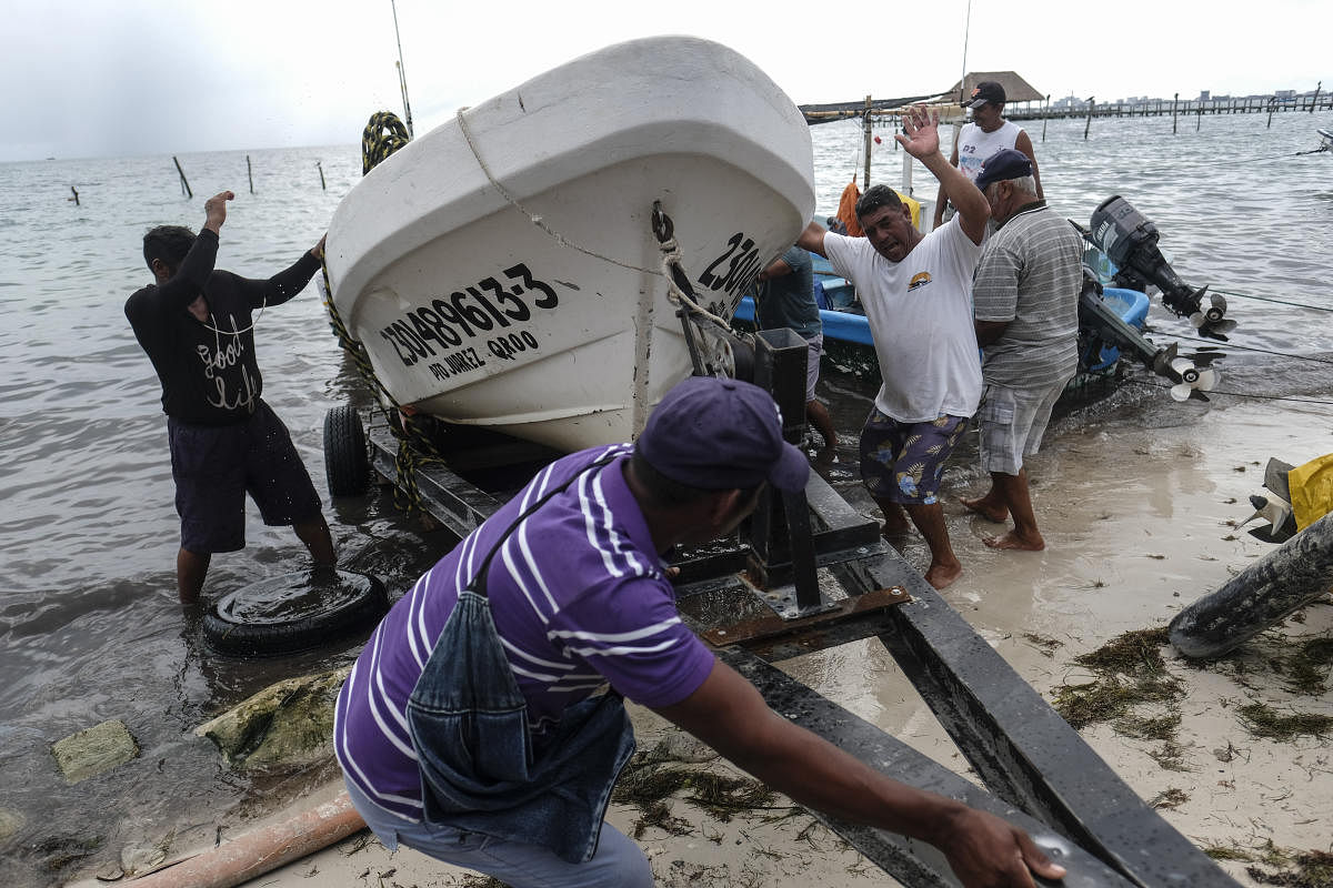 Fishermen pull in a boat before the arrival of Hurricane Delta in Puerto Juarez, Cancun, Mexico. Hurricane Delta rapidly intensified into a potentially catastrophic Category 4 hurricane Tuesday on a course to hammer southeastern Mexico and then continue on to the US Gulf coast this week. Credit: AP Photo