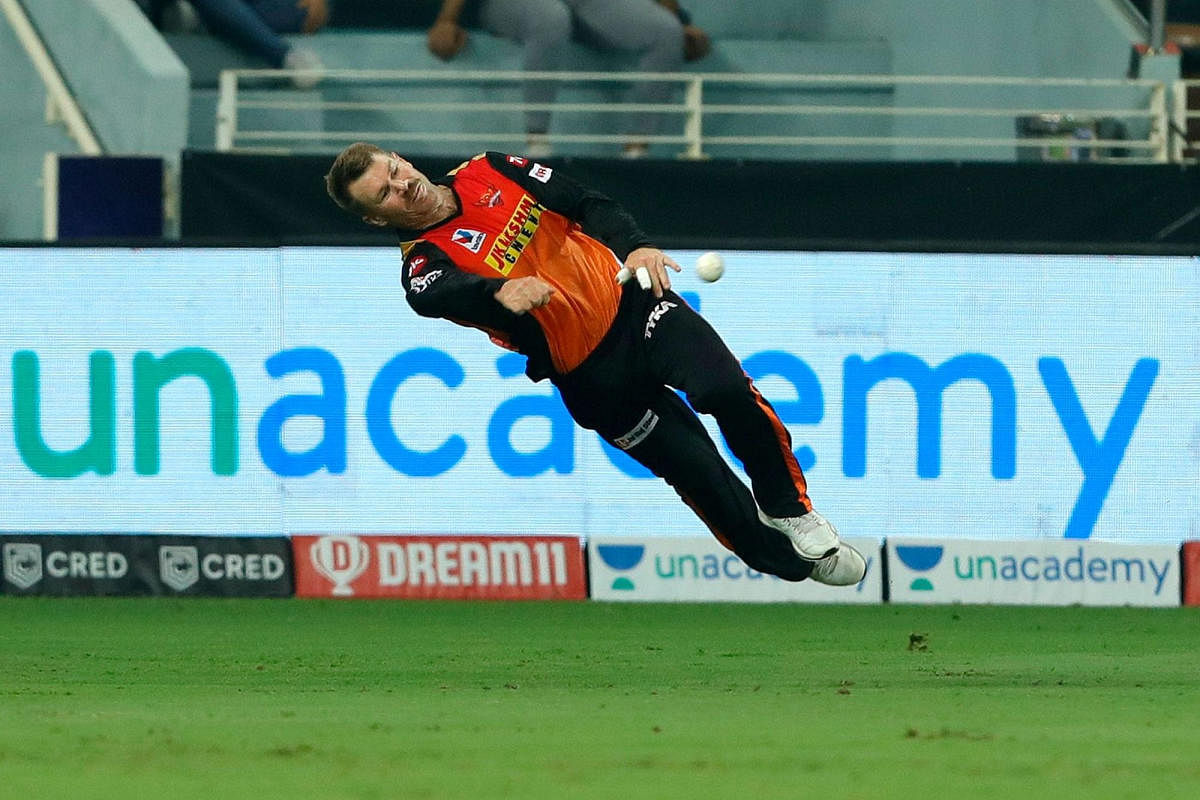 Sunrisers Hyderbad player David Warner jumps to catch ball. Credit: PTI Photo