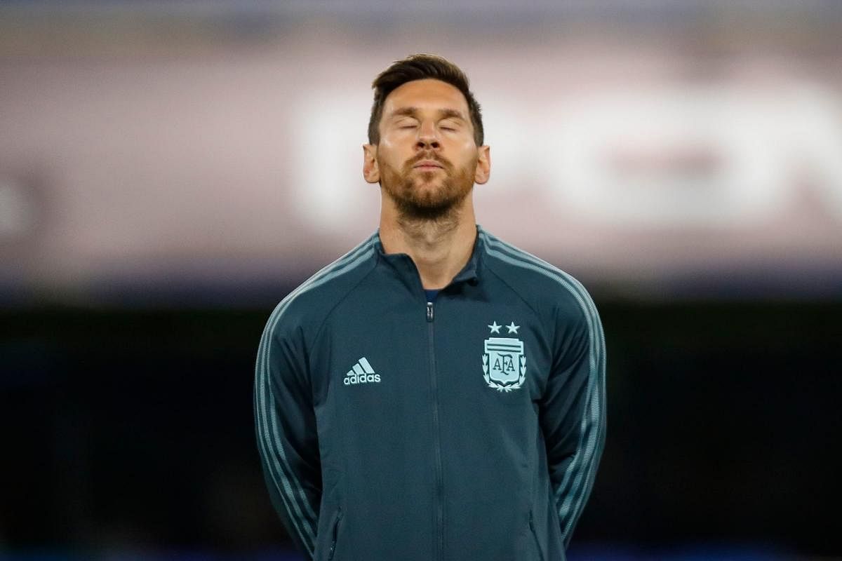 Argentina's Lionel Messi listens to the national anthem before the 2022 FIFA World Cup South American qualifier football match against Ecuador at La Bombonera stadium in Buenos Aires. Credit: AFP Photo