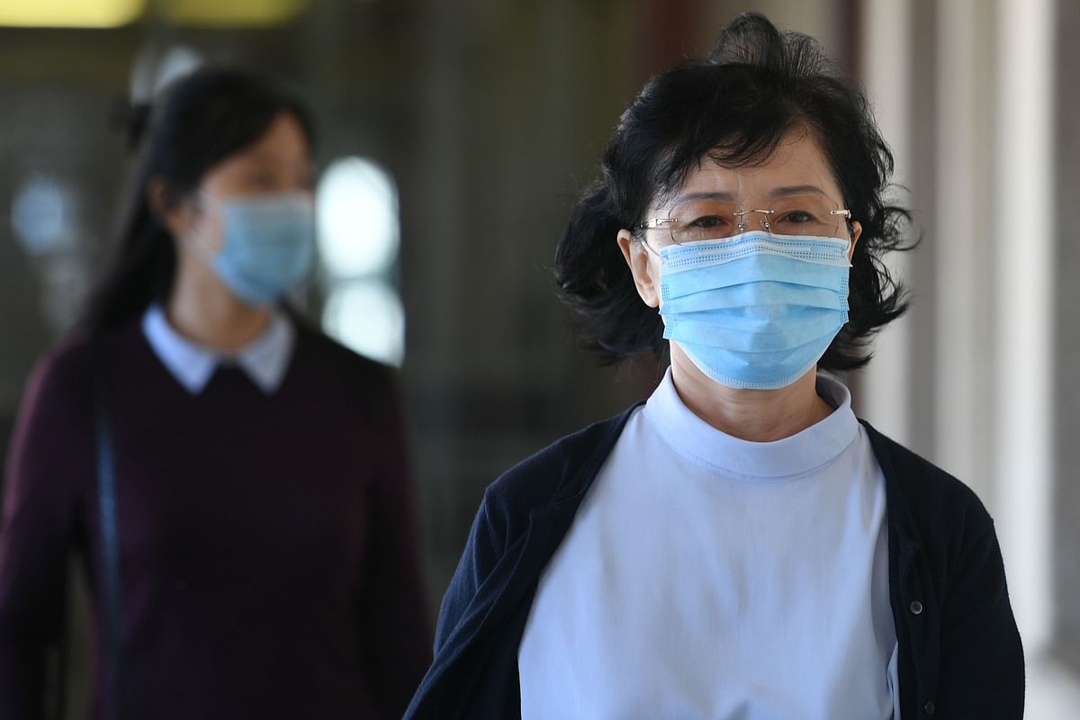 Kang Son Bi (R), wife of Mun Chol Myong, a North Korean man who faces possible extradition from Malaysia to the US on money laundering charges, arrives at the Duta court complex in Kuala Lumpur. Credit: AFP Photo