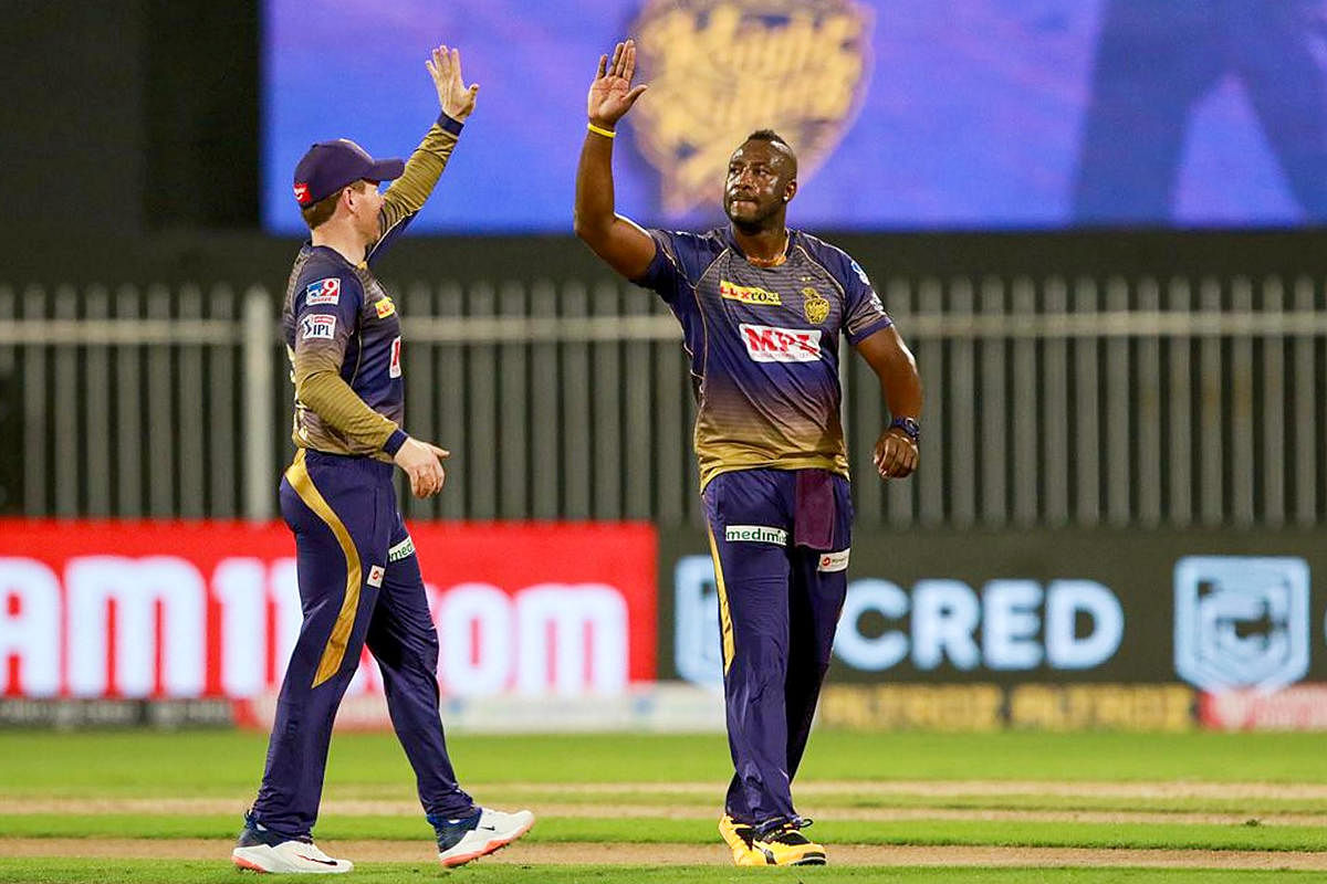 Kolkata Knight Riders player Andre Russell celebrates the wicket of Royal Challengers Bangalore batsman Devdutt Padikkal during a cricket match of IPL 2020. Credit: PTI Photo.