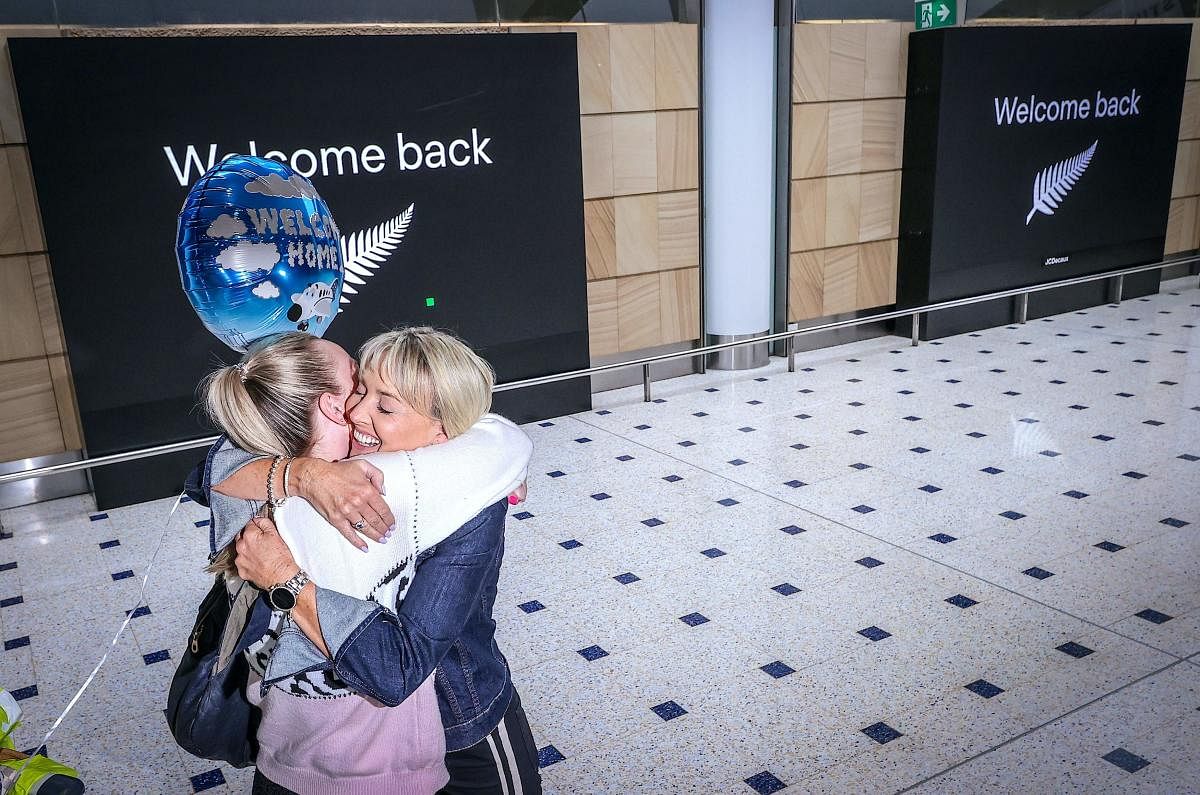 A passenger hugs a family member upon arrival from New Zealand at Sydney International Airport. Credit: AFP Photo