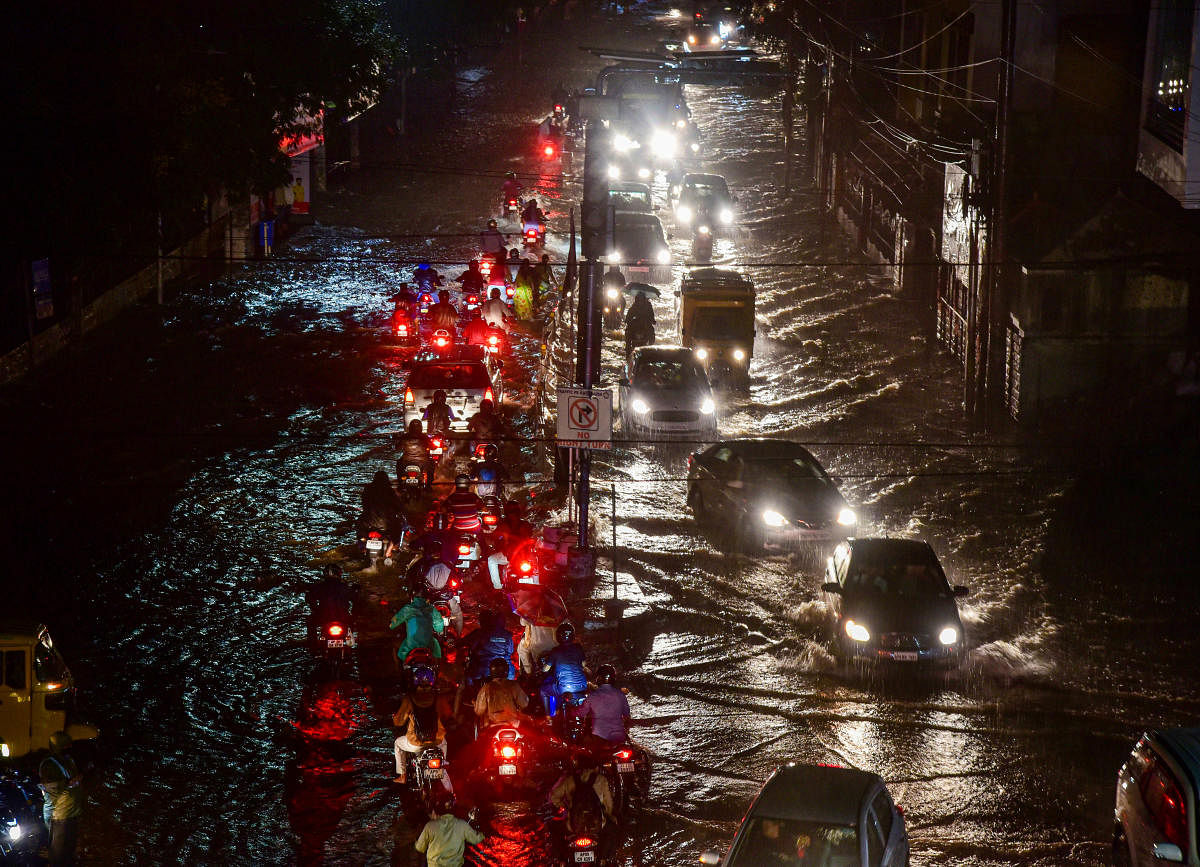 Vehicles ply on a waterlogged street, in Hyderabad. Credit: PTI Photo