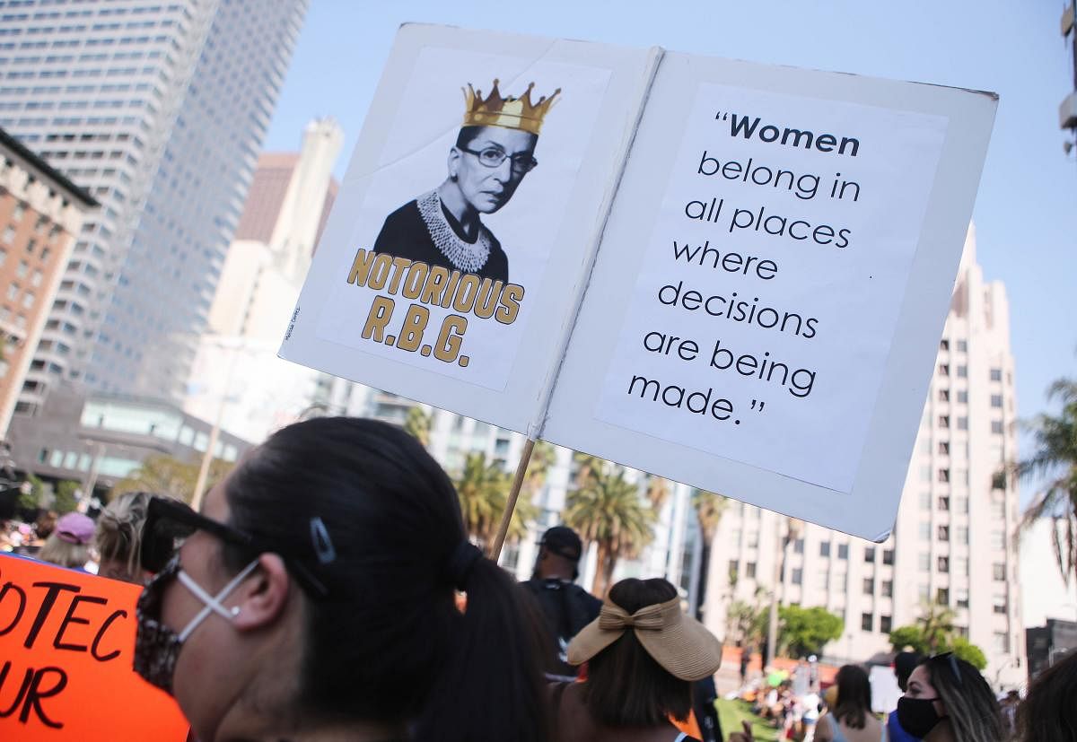 A protester holds a sign depicting late Supreme Court Justice Ruth Bader Ginsberg during a Women’s March advocating for women's rights in Los Angeles, California. Thousands of women nationwide were expected to participate in pre-election demonstrations encouraging voters to oppose President Donald Trump and other Republican candidates. Credit: AFP Photo