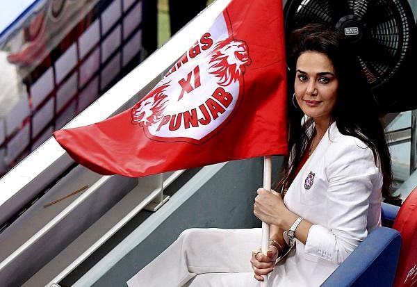 Kings XI Punjab owner Preity Zinta holds her team's flag during IPL 2020 cricket match. Credit: PTI Photo
