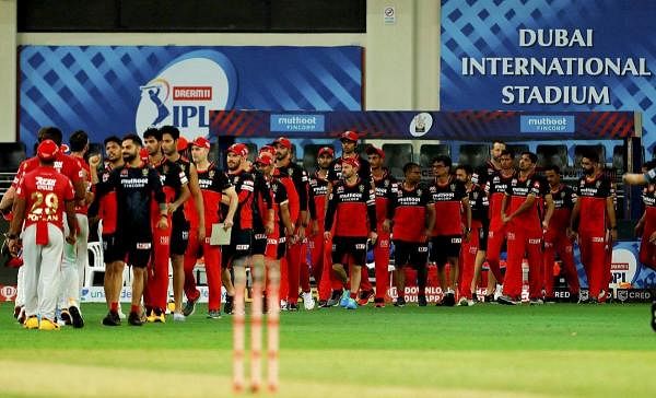Royal Challengers Bangalore (RCB) players congratulate Kings XI Punjab players after the latter won their IPL 2020 cricket match. Credit: PTI Photo