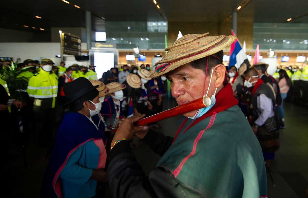 Misak indigenous people play music and dance during a protest against the government, the violence they suffer in their territories and murders of social leaders at the El Dorado airport in Bogota. Credit: AFP Photo