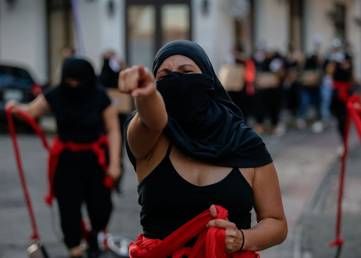 A woman gestures during a women protest against corruption and the lack of measures with a gender perspective in Panama City. Credit: AFP Photo