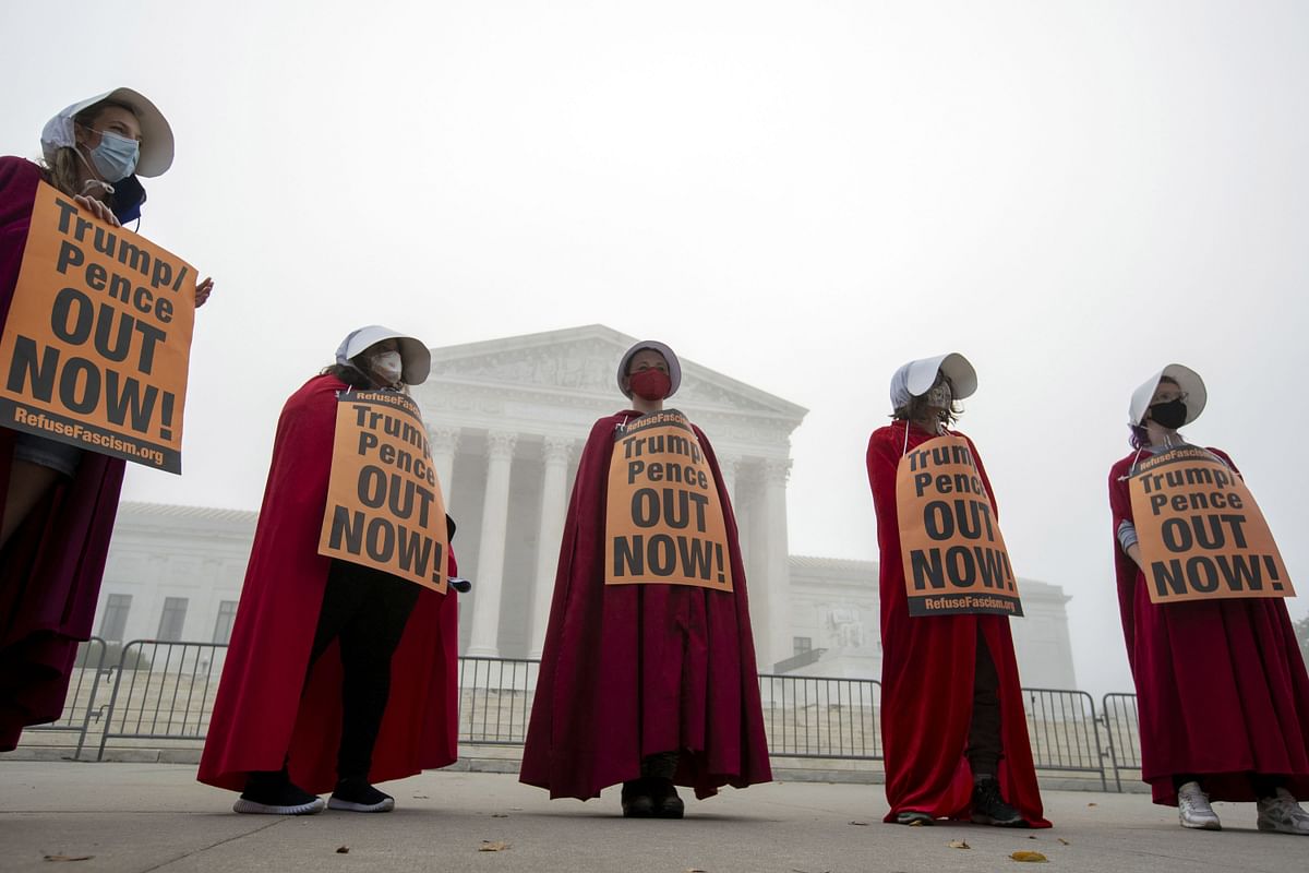 Activists opposed to the confirmation of President Donald Trump's Supreme Court nominee, Judge Amy Coney Barrett, dressed as characters from