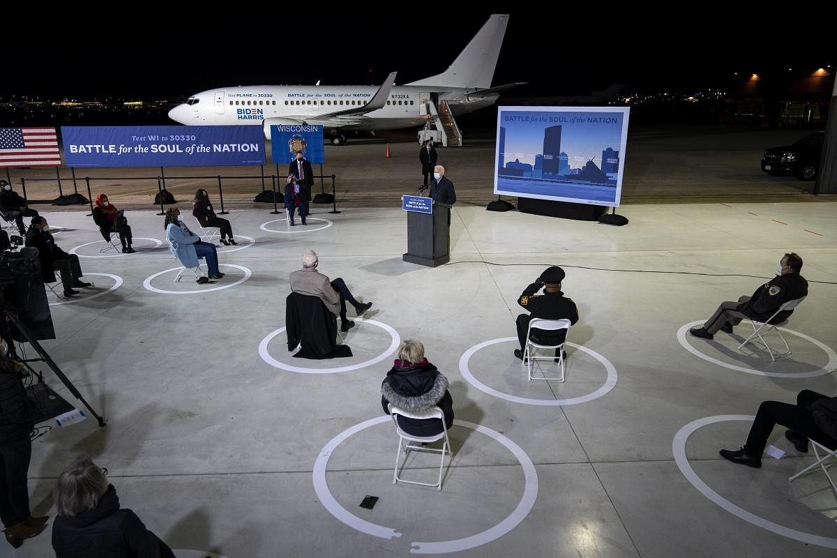 With a socially distanced audience of supporters and journalists, Democratic presidential nominee Joe Biden delivers remarks at Milwaukee Mitchell International Airport in Milwaukee, Wisconsin. Credit: AFP Photo