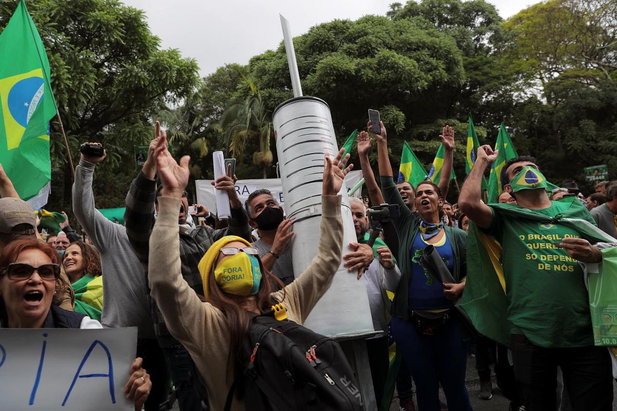 Demonstrators carry a giant syringe as they protest against Sao Paulo state governor Joao Doria and China's Sinovac potential coronavirus disease vaccine in Sao Paulo, Brazil. Credit: Reuters Photo