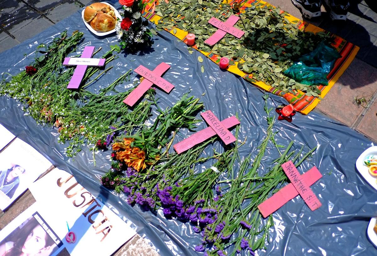 Crucifixes to honor victims of femicide are seen as women protest on the Day of the Dead celebrations in La Paz, Bolivia. Credit: Reuters Photo