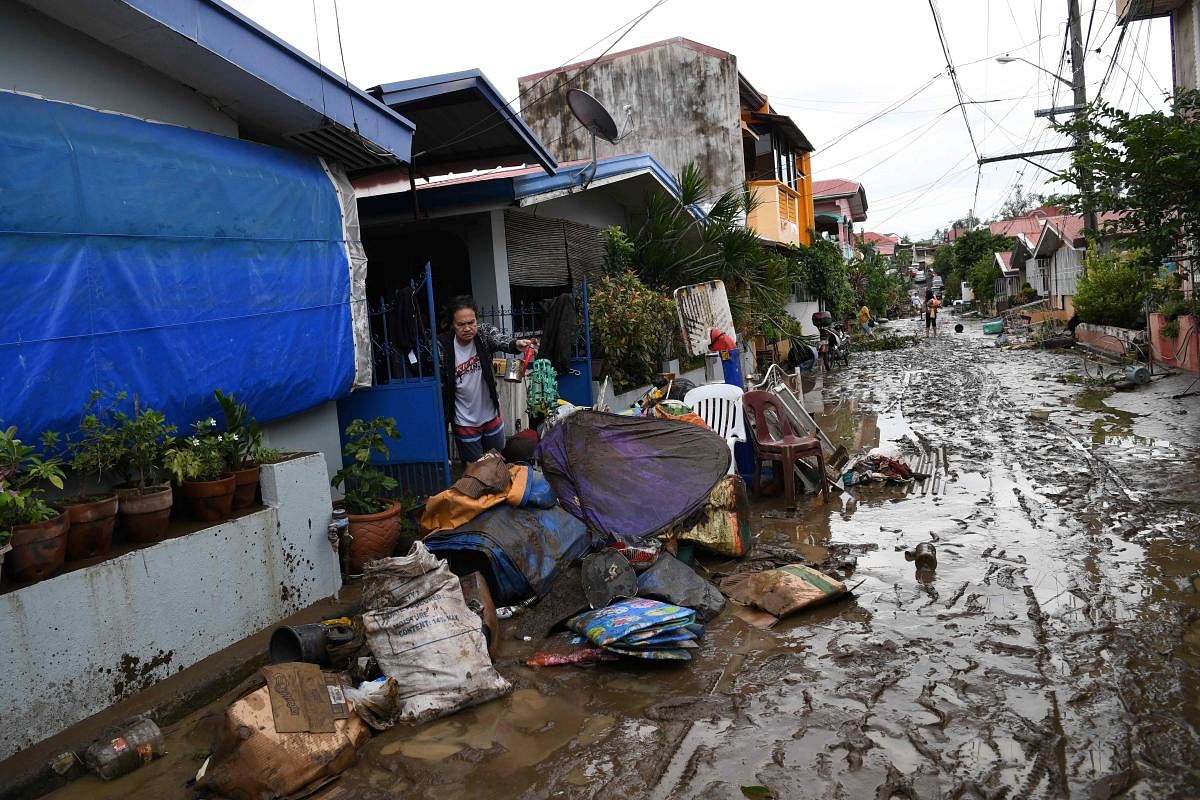 Residents clean their homes following flooding in Batangas City after super Typhoon Goni made landfall in the Philippines. Credit: AFP Photo