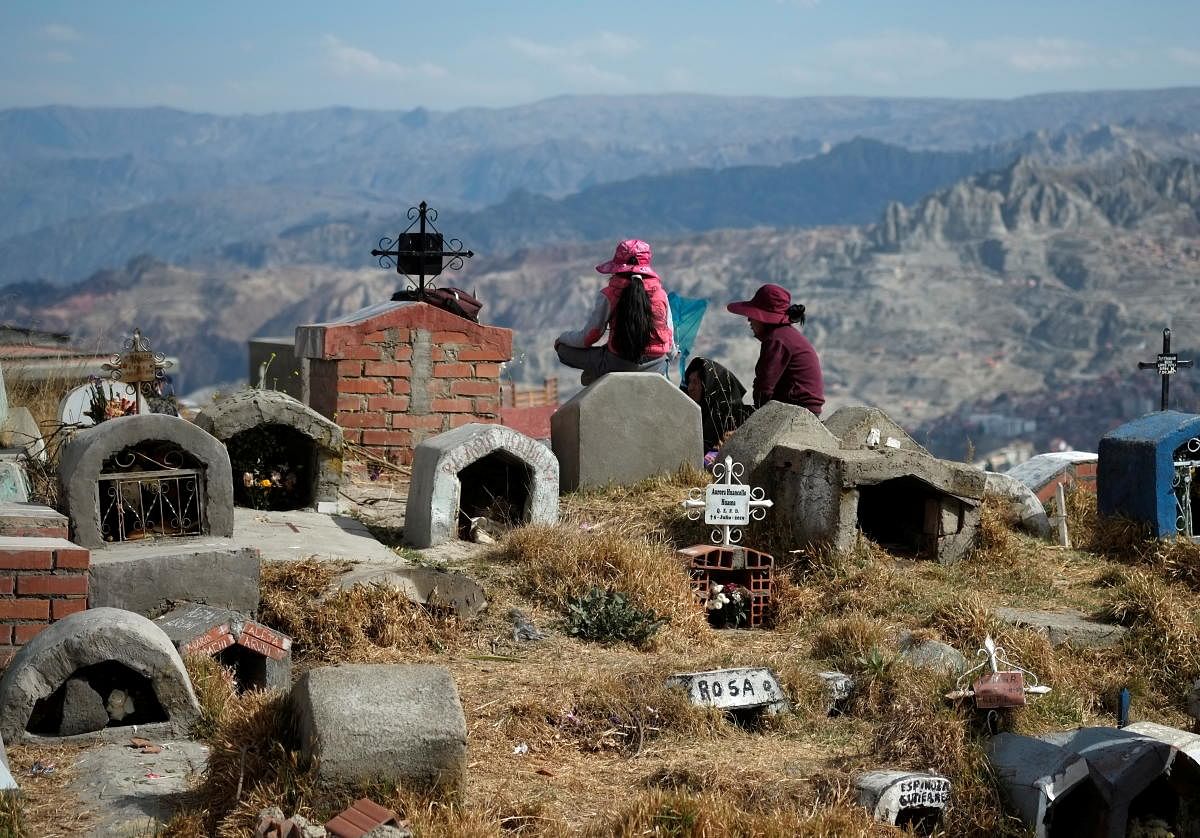 A family rest at the Llamita cemetery during the All Saints' Day in La Paz, Bolivia. Credit Reuters Photo