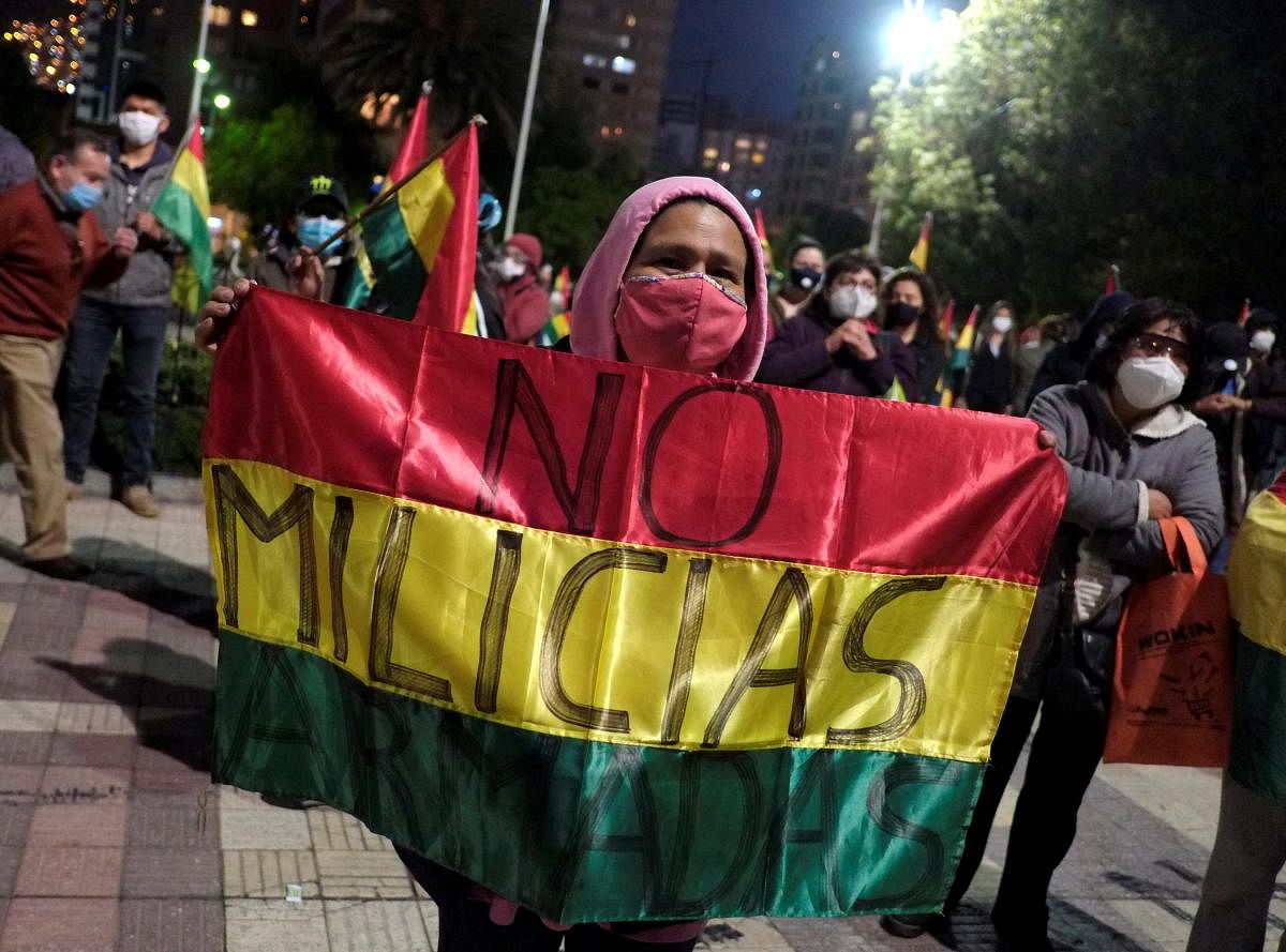 A woman holds a flag that reads
