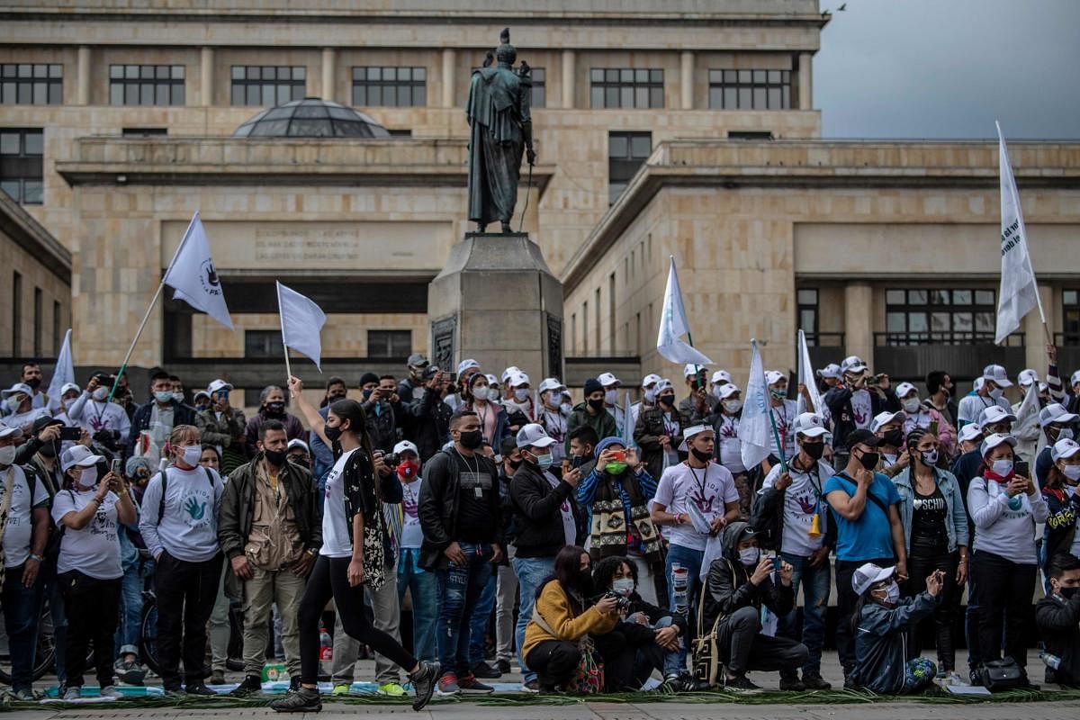 A model presents a creation by former FARC combatants during a demonstration demanding peace accords to be respected, at Bolivar square in Bogota, Colombia. Credit: AFP Photo