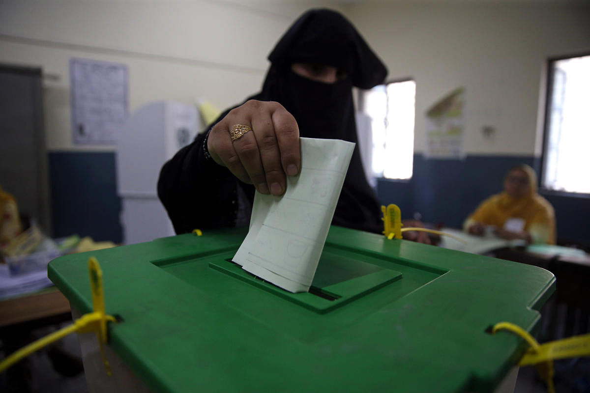 A voter casts her vote at a polling station during the general election in Islamabad. Less than half of Pakistan's eligible voters at 40.7% voted in 2018 elections. Credit: Reuters Photo