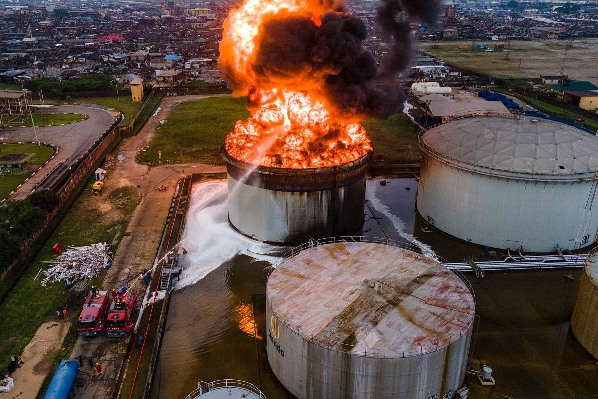 An aerial view shows an oil tanker on fire at the OVH Energy Marketing (a licensee of the Oando retail brand and ASPM Limited) in Apapa, Lagos. The cause of the fire is still unknown at this point but the fire service is on the ground to control the fire outbreak. Credit: AFP Photo