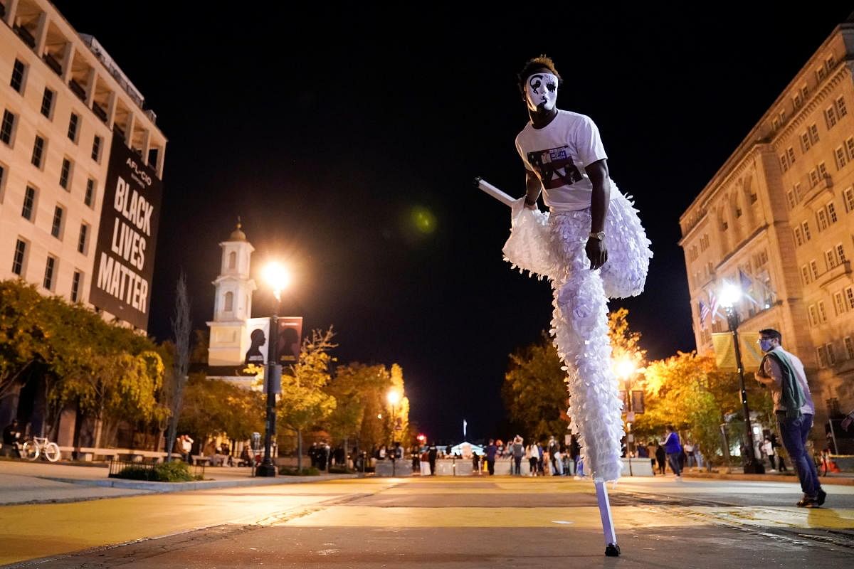 Renzie The Choreographer dances on stilts on Black Lives Matter Plaza near the White House the evening after a presidential election victory was called for former Vice President Joe Biden, in Washington, US. Credit: Reuters Photo