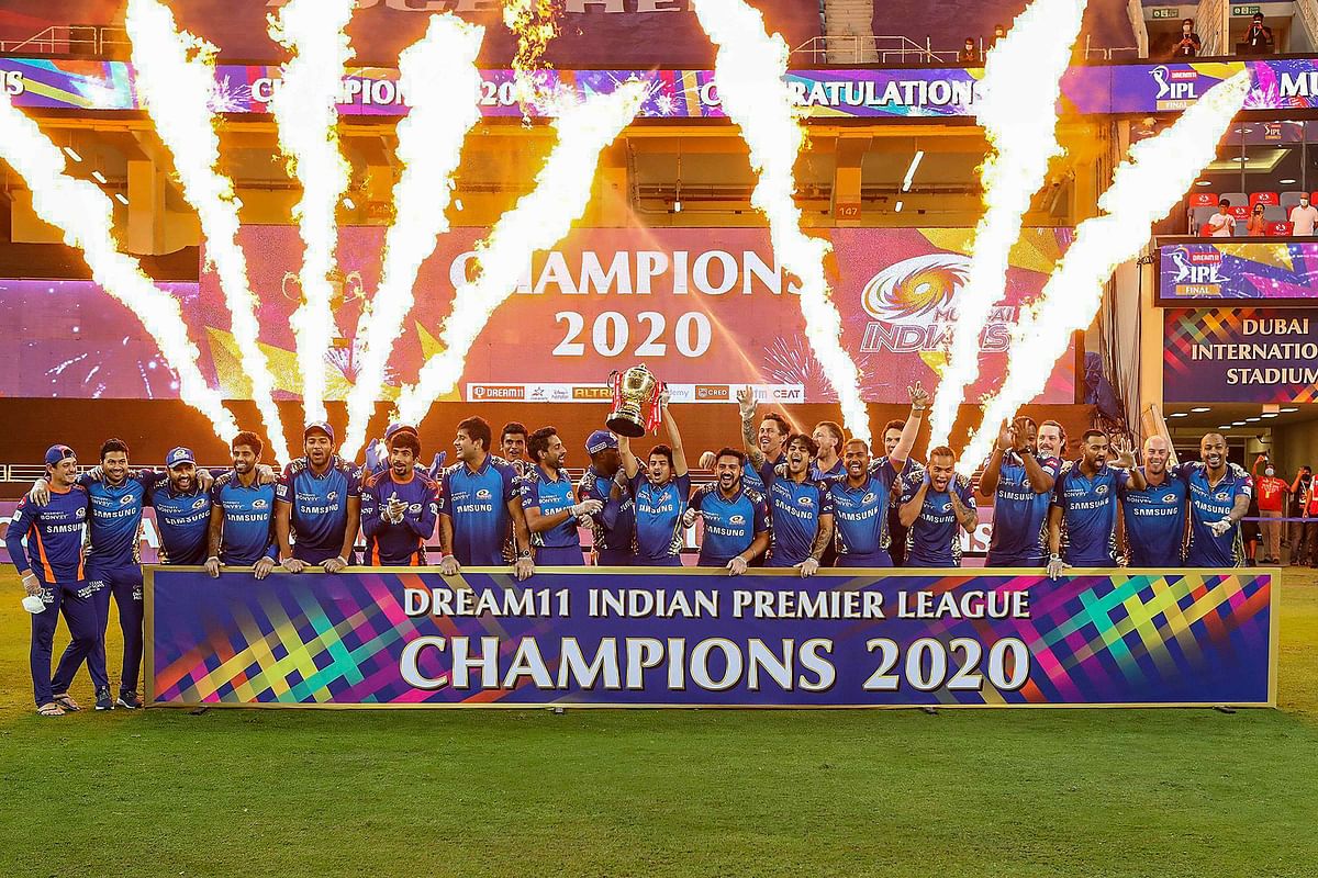 Mumbai Indians team pose with the winners trophy after winning the final cricket match of the Indian Premier League (IPL) T20 against Delhi Capitals, at Dubai International Cricket Stadium in Dubai. Credit: PTI