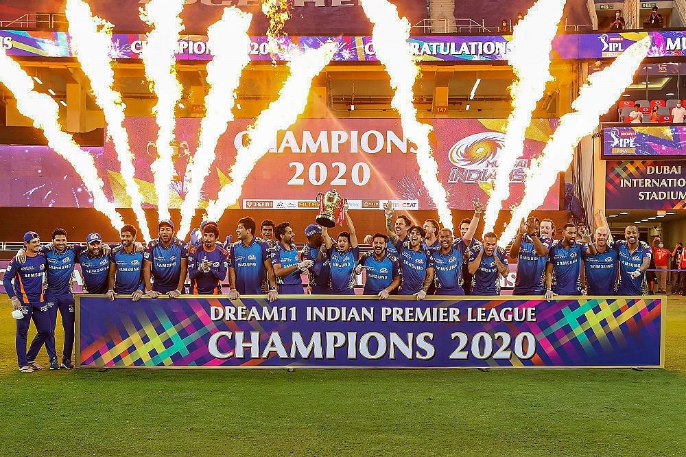 Mumbai Indians team pose with the winners trophy after winning the final cricket match of the Indian Premier League (IPL) T20 against Delhi Capitals. Credits: PTI Photo