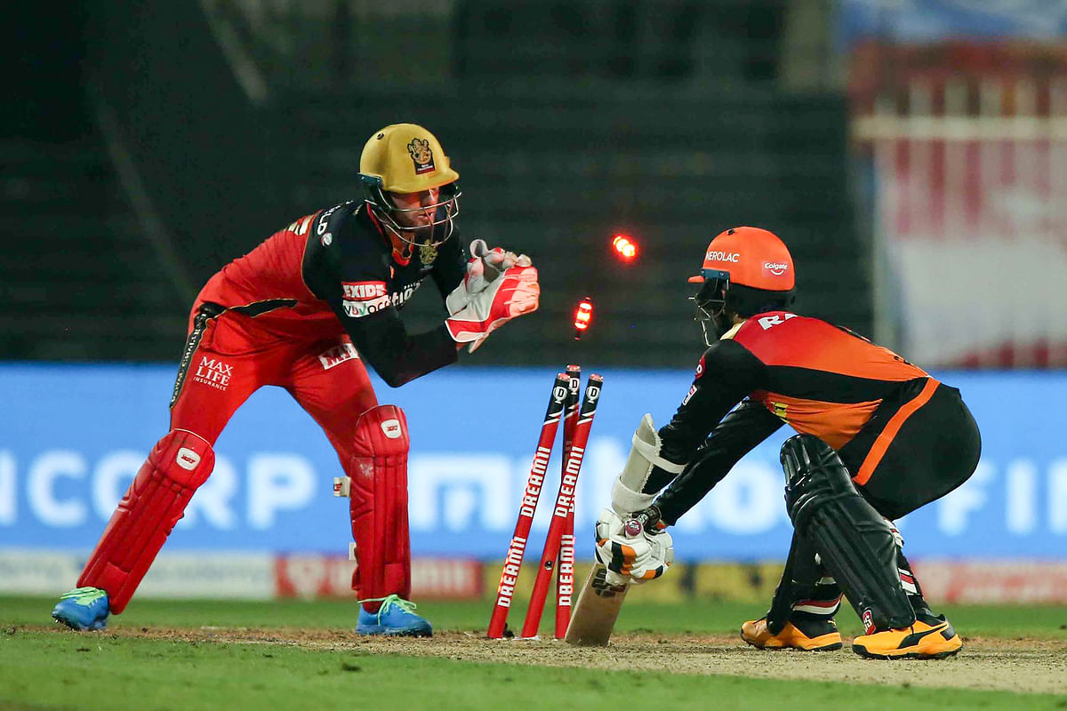 Sunrisers Hyderabad batsman Wriddhiman Saha stumped by Royal Challengers Bangalore player AB de Villiers. Credit: PTI