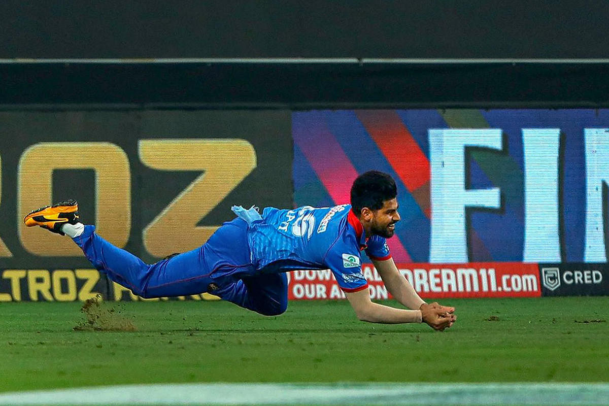 Delhi Capitals player Lalit Yadav takes a catch of Mumbai Indians batsman Rohit Sharma. Credit: PTI Photo