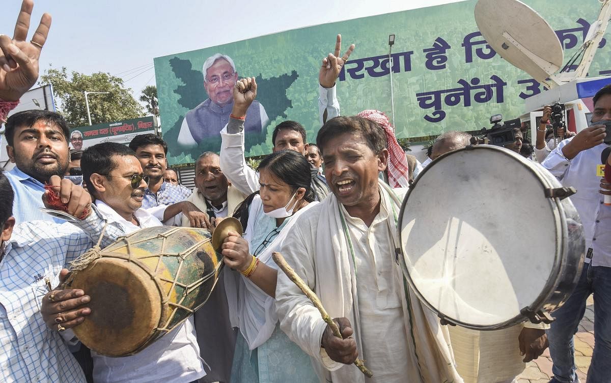 Janata Dal (United) supporters react as officials count votes during counting day of Bihar Assembly polls. Credit: PTI Photo