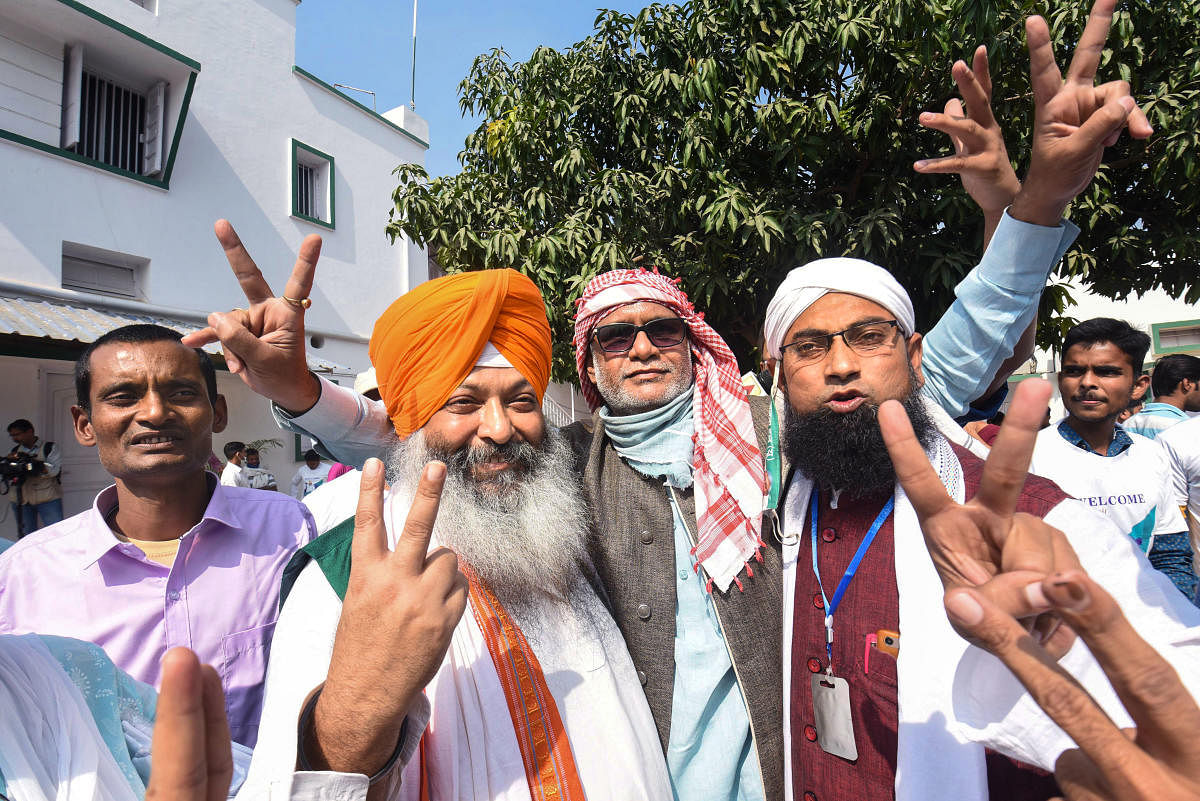 NDA supporters flash victory signs as they celebrate the alliance's lead during counting of votes for Bihar Assembly elections. Credit: PTI Photo