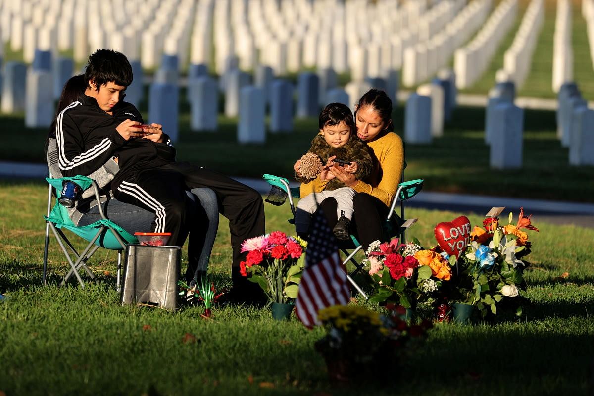 People look at graves at Los Angeles National Cemetery on Veterans’ Day in Los Angeles. Credit: Reuters Photo