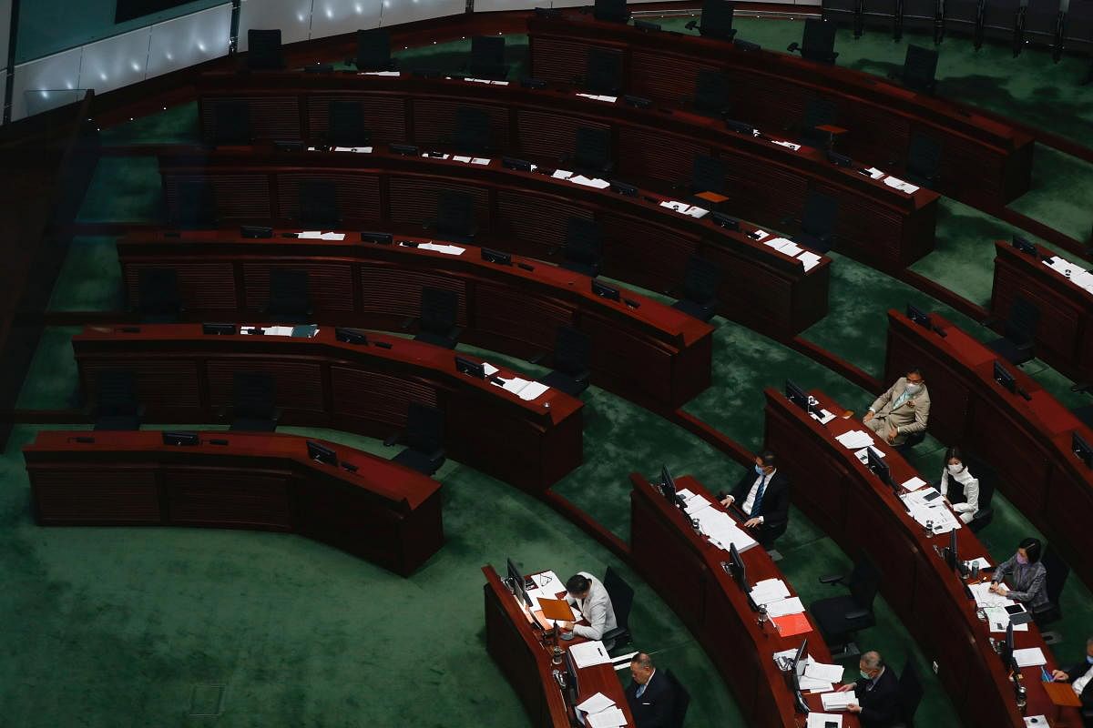 Empty seats are seen inside the chamber during council meeting after pan-democratic legislators resign in protest against the dismissal of four of their colleagues from the city assembly after Beijing passed a new resolution, in Hong Kong. Credit: Reuters Photo