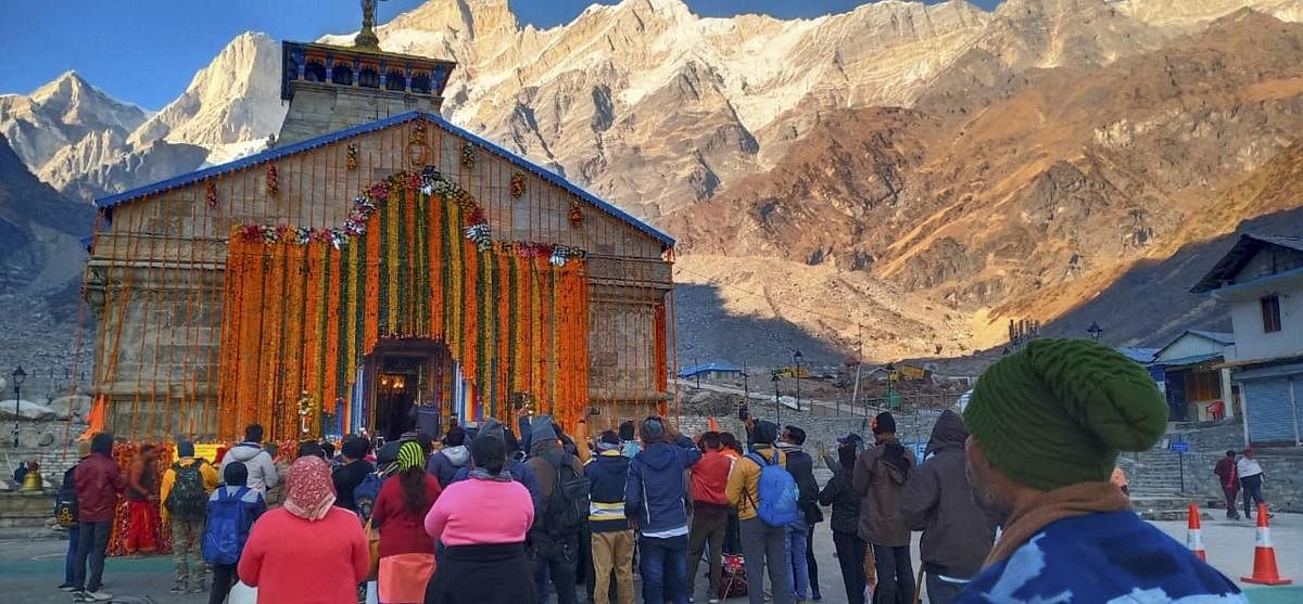 Devotees decorate Kedarnath temple with 10 quintals of flowers on the eve of the Diwali festival, in Kedarnath. Credit: PTI Photo