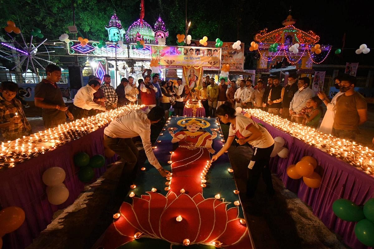 People light lamps at a temple on the eve of the Diwali festival in Bhopal. Credit: PTI Photo