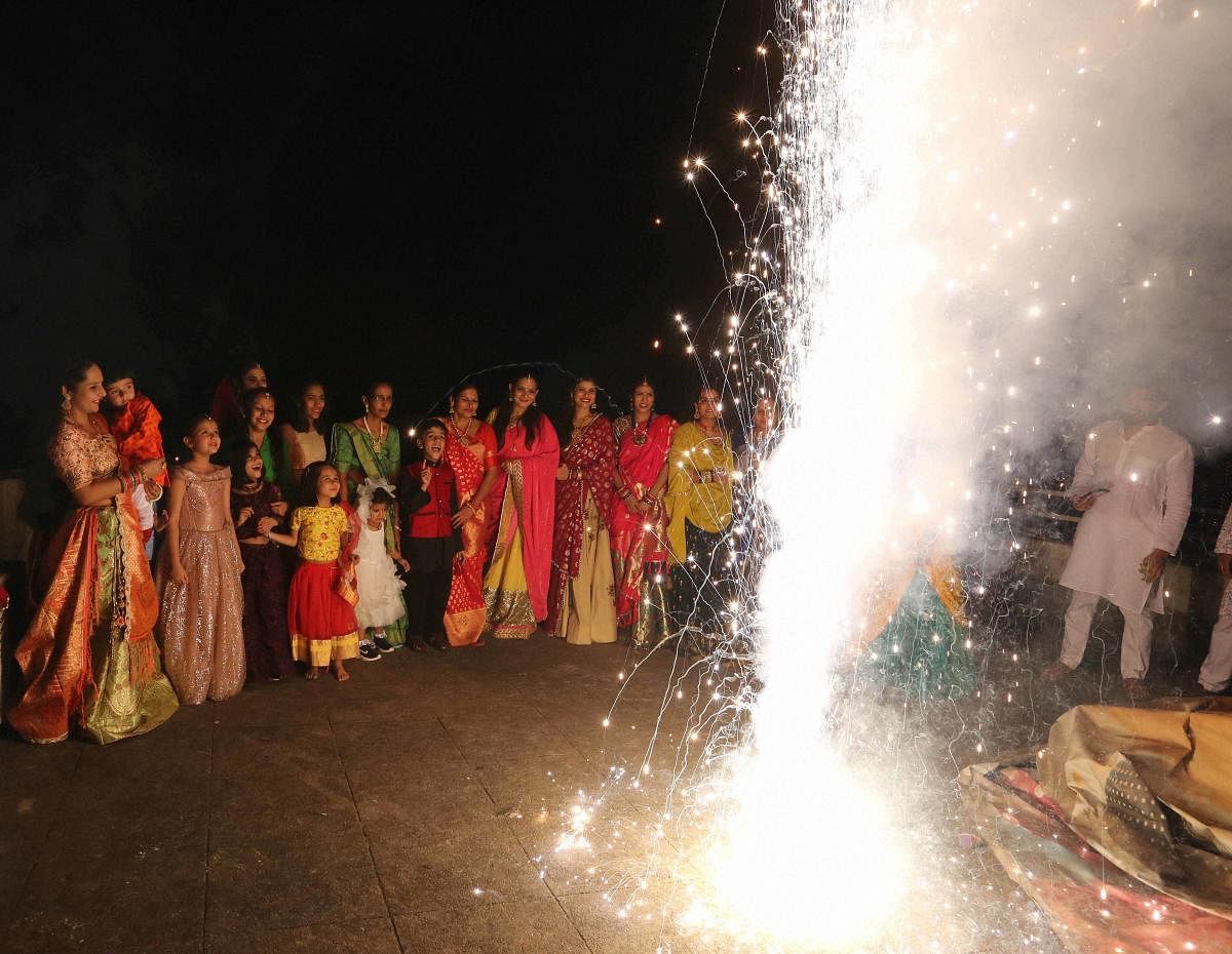 Women burn firecrackers as they celebrate Diwali festival in Bhopal. Credit: PTI Photo