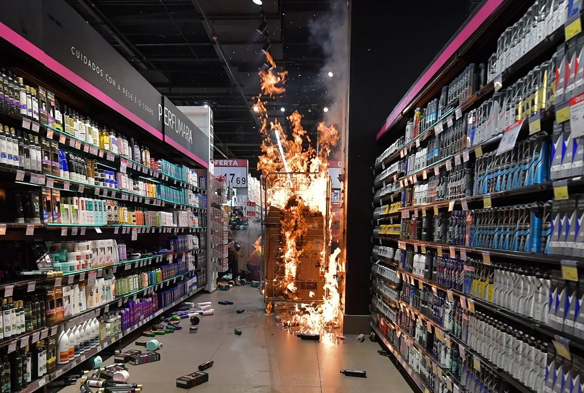 Products burn at a supermarket Carrefour in Sao Paulo, Brazil, on Black Consciousness Day after protesters invaded the place during a protest against racism and the death on the eve of a black man who was beaten by white security agents in a supermarket of the same chain in Porto Alegre and who later died. In Brazil, around 55% of the population identifies as black or mixed-race. Credit: AFP Photo
