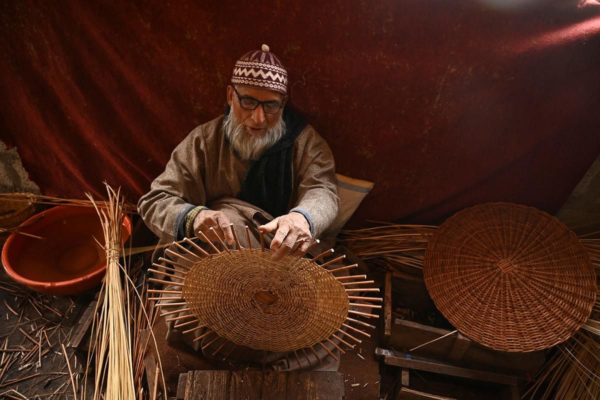 A craftsman makes a wicker basket at a workshop on the outskirts of Srinagar, Kashmir. Credit: AFP Photo