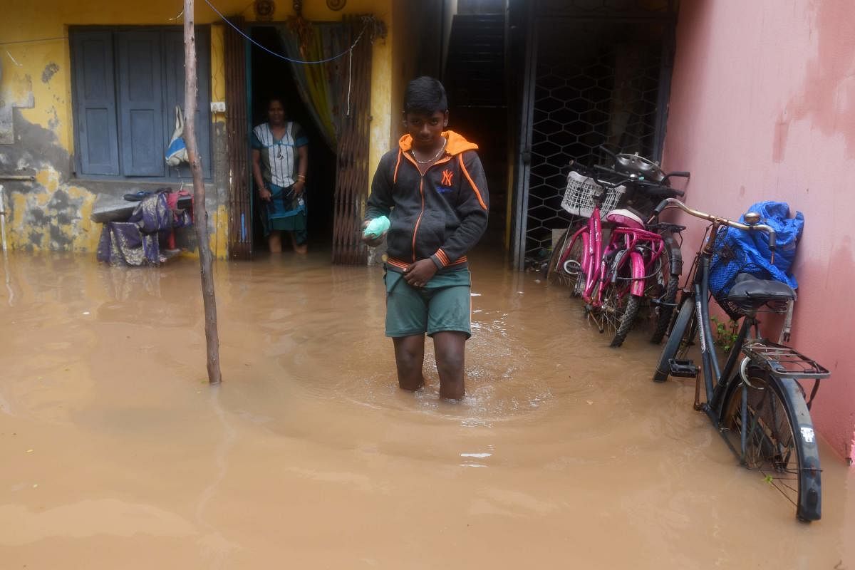 A boy wades through waterlogged water in a residential area following heavy rains after Cyclone Nivar landfall, in Puducherry. Credit: AFP Photo