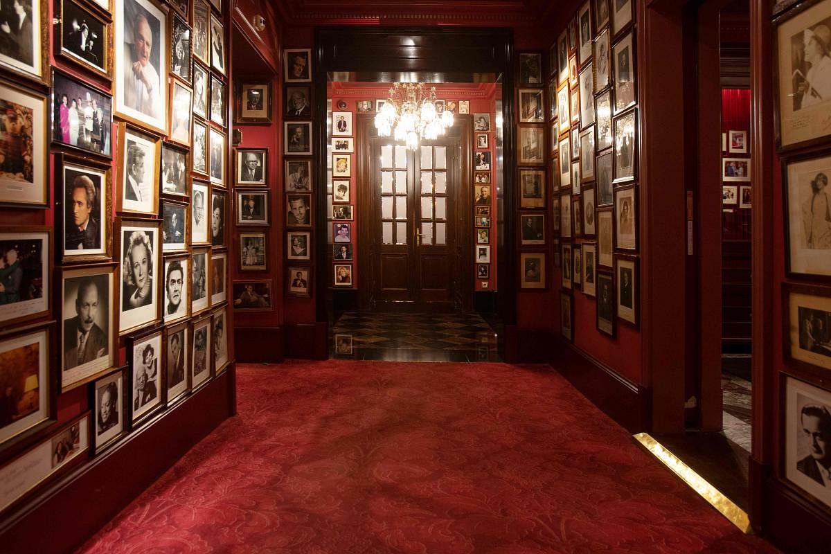 A corridor in the hotel with historical photos of famous guests of the Hotel Sacher is pictured in Vienna. Since the emergence of the coronavirus pandemic in Austria, the famous Sacher, which faces the Opera, has been trying to get through the crisis by drawing on the examples of resilience inherited from its long imperial and royal tradition. Credit: AFP Photo