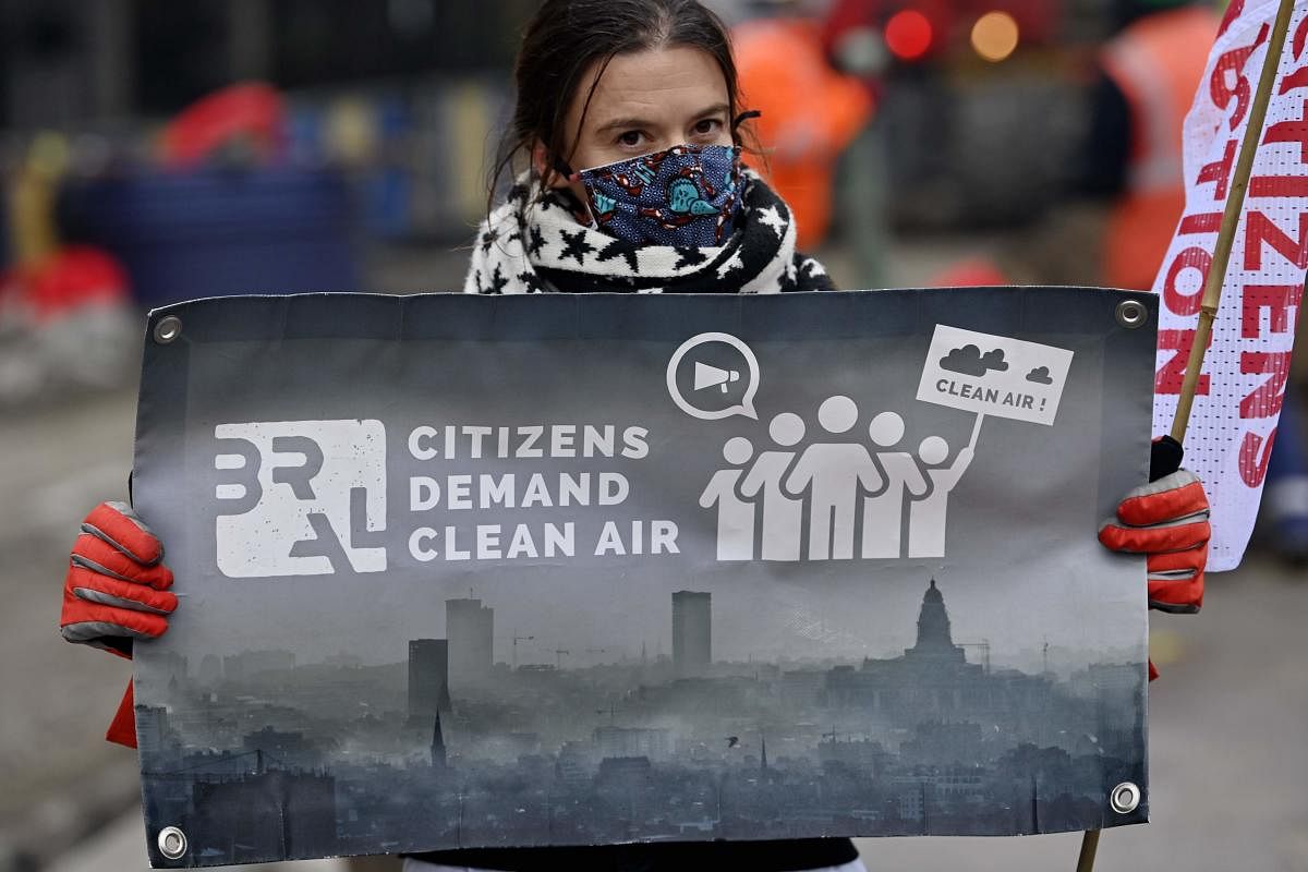 A protester holds a banner at the start of a three-day-demonstration organised by the coalition Climate Belgium (Greenpeace, BBL, Oxfam solidarity, Youth for Climate) in Brussels, Belgium. Credit: AFP Photo