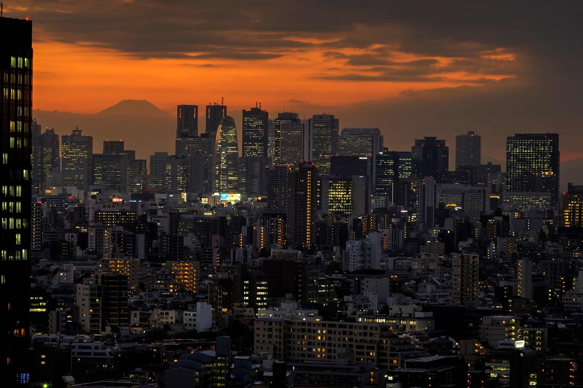 Mount Fuji (background L), Japan's highest mountain at 3,776 meters (12,388 feet), is seen behind skyscrapers in Tokyo's Shinjuku area. Credit: AFP Photo