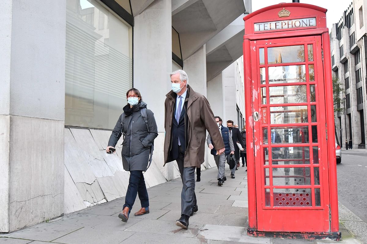 EU chief negotiator Michel Barnier (2L), wearing a protective face covering to combat the spread of the coronavirus, walks in Westminster back to a conference centre in central London. Credit: AFP Photo