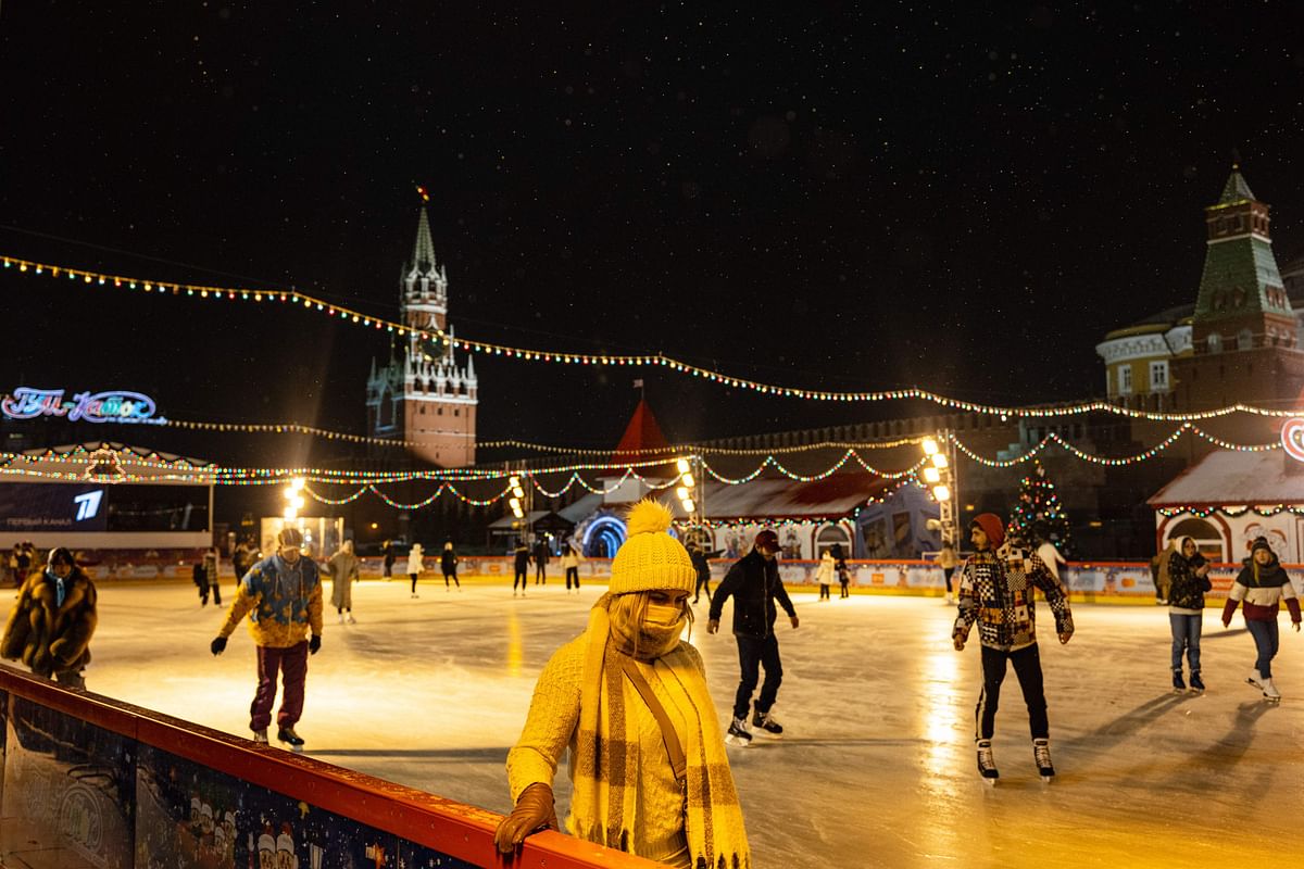 People wear protective face masks as they skate at an outdoor ice skating rink in the Red Square in central Moscow. Credit: AFP Photo