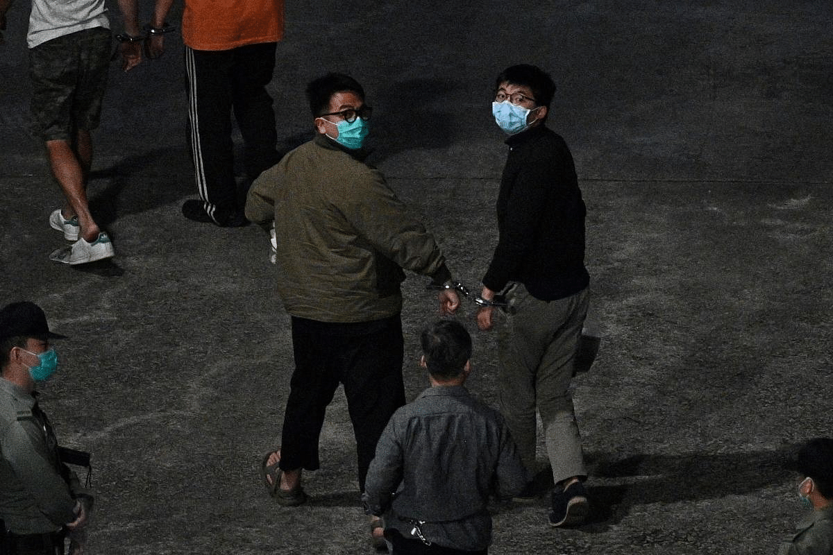 Activists Joshua Wong (R) and Ivan Lam (L) arrive at Lai Chi Kok Reception Centre in Hong Kong on December 2, 2020, after being sentenced after pleading guilty to inciting a rally during pro-democracy protests in 2019, deepening the crackdown against Beijing's critics. Credit: AFP Photo