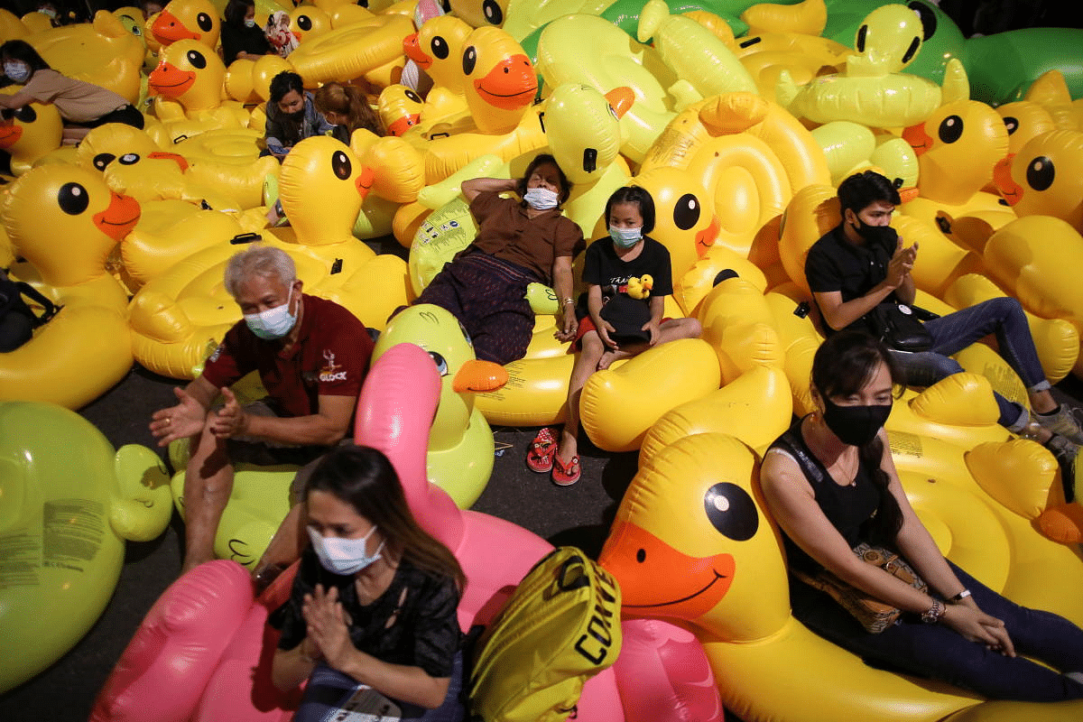 Pro-democracy activists sit on inflatable ducks as they protest after the constitutional court's ruling on Prime Minister Prayuth Chan-ocha's conflict of interest case, in Bangkok, Thailand. Credit: Reuters Photo