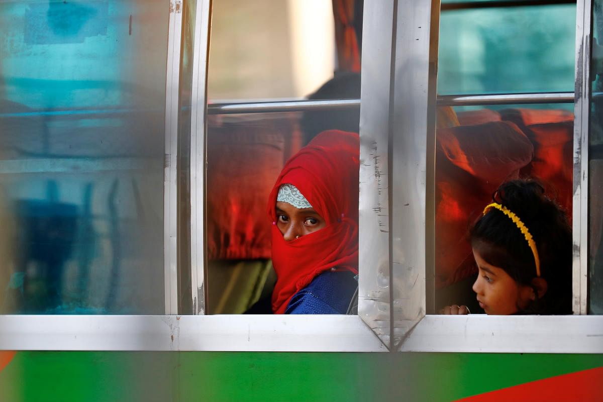 Rohingyas who will be shifted to Bhasan Char island are seen onboard a bus in Chattogram, Bangladesh. Credit: Reuters Photo