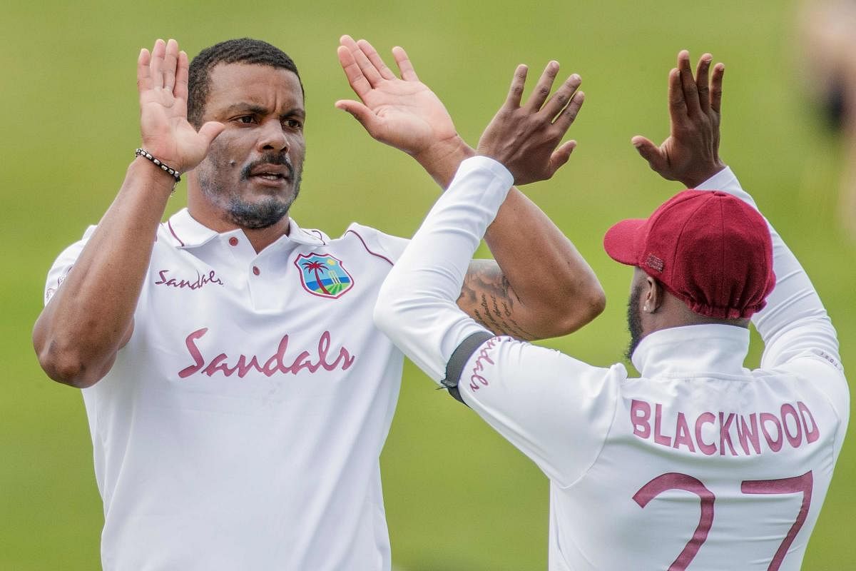 West Indies' Shannon Gabriel (L) celebrates after dismissing New Zealand's Ross Taylor with teammate Jermaine Blackwood during the second day of the first test cricket match between New Zealand and West Indies at Seddon Park in Hamilton, New Zealand. Credit: AFP Photo