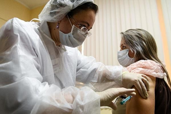A nurse wearing a face mask proceeds to administer the Sputnik V (Gam-COVID-Vac) vaccine against Covid-19 at a clinic in Moscow. Credit: AFP