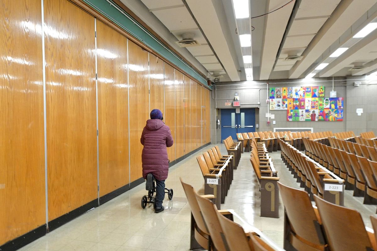 New York City reopens public schools amid Covid-19 pandemic. Principal Alice Hom uses a knee walker scooter due to an injury to get around on the first day back to school on December 7 at Yung Wing School P.S. 124 in New York City. Credit: AFP