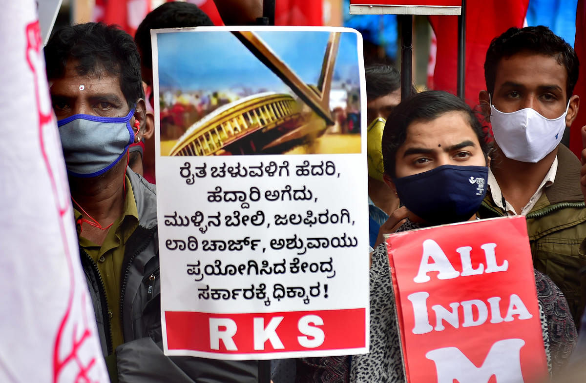 Members of various organisations participate in a protest in support of the nationwide strike, called by agitating farmers to press for repeal of the Centre's farm laws, in Bengaluru. Credit: PTI Photo.