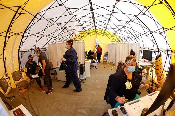 St Mary Medical Center staff work inside a triage tent to handle the overflow at its 200 bed hospital during the outbreak of the Covid-19 in Apple Valley, California, US. Credit: Reuters